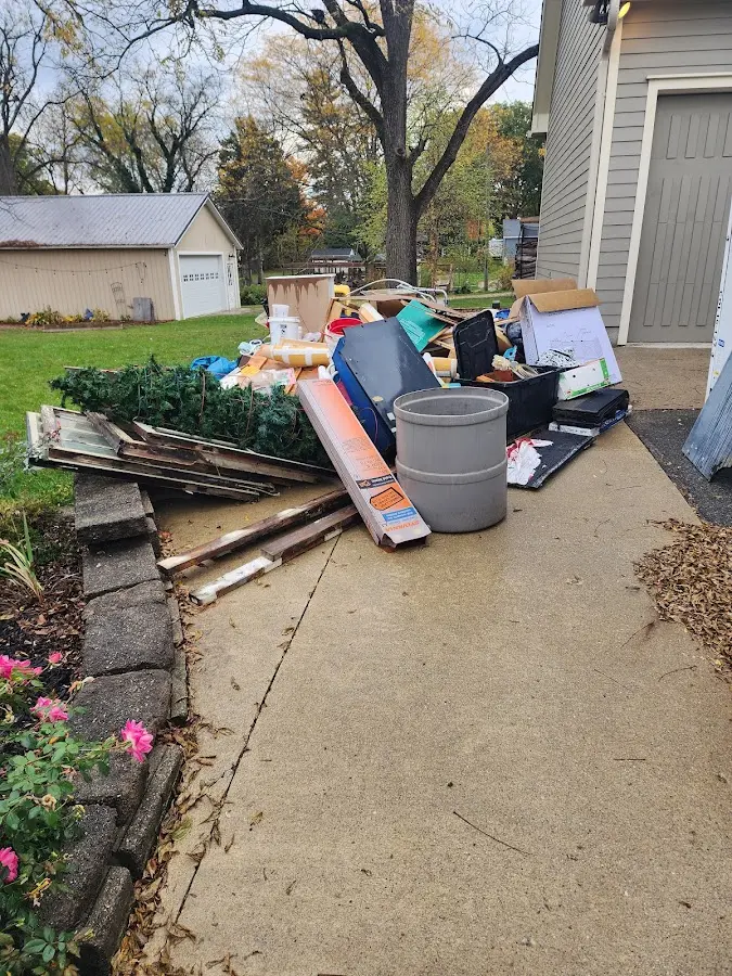 Dumpster being loaded with debris for Commercial Dumpster Rental in Madera Acres